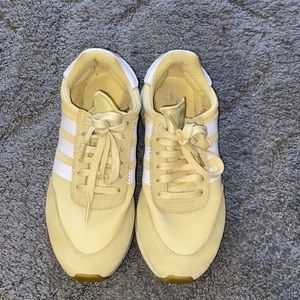 Yellow adidas gym shoes.